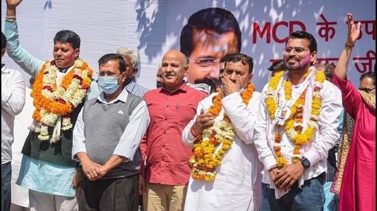 Delhi CM Arvind Kejriwal and deputy CM Manish Sisodia with Aam Aadmi Party (AAP) candidates after emerging victorious in five bypolls to the Municipal Corporation of Delhi, in New Delhi, on March 3. (PTI)