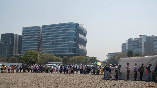 People queue to get vaccinated against Covid-19 outside BKC vaccination centre in Mumbai on March 2. Covid-19 recoveries reached 10,812044 with 13,123 recoveries reported between March 2 and 3 morning.(Pratik Chorge / HT Photo)