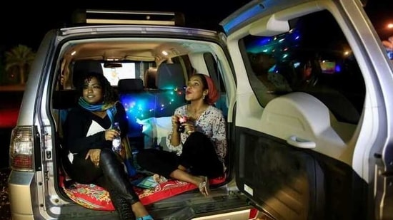 Women sit in a car as they watch a screening of the Sudanese European Film Festival at an outdoor, drive-through cinema for visitors, adhering to coronavirus disease (COVID-19) restrictions, in Khartoum, Sudan February 28, 2021. Picture taken February 28, 2021. REUTERS/Mohamed Nureldin Abdallah(REUTERS)