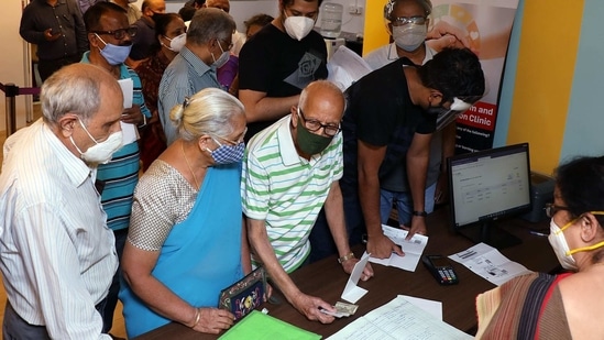 Senior citizens enquiring at the registration desk as they arrive to get the first dose of COVID-19 vaccine during the second phase of the COVID-19 vaccination in Bengaluru on Monday(ANI)