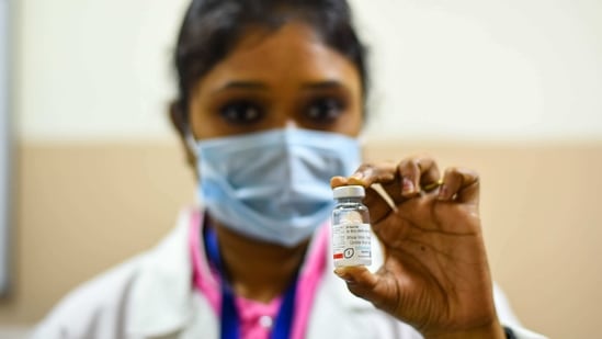 A health worker holding up a Covaxin Covid-19 vaccine vial at Delhi Heart and Lung Institute in New Delhi. (Amal KS/ Hindustan Times) A health worker holding up a Covaxin Covid-19 vaccine vial at Delhi Heart and Lung Institute in New Delhi. (Amal KS/ Hindustan Times)
