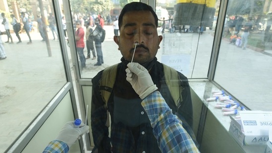 A health worker collects a swab sample from a man for a Covid-19 test, at Sector 30 District Hospital, in Noida on March 1. With an infection tally higher than the recovery, India's active caseload on Wednesday stood at 1,70,126.(Sunil Ghosh / HT Photo)