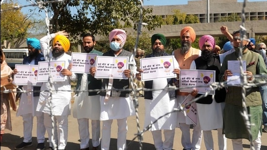 Leader of opposition Harpal Cheema and other AAP MLAs staging a walkout from the Punjab Vidhan Sabha on Wednesday. (Ravi Kumar/HT)