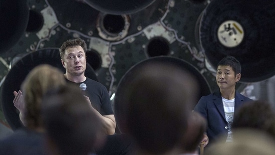 (FILES) This file photo taken on September 17, 2018 shows SpaceX founder Elon Musk (L) and Japanese billionaire Yusaku Maezawa (R) speaking before a Falcon 9 rocket during the announcement that Maezawa will be the first private passenger who will fly around the Moon aboard the SpaceX BFR launch vehicle, at the SpaceX headquarters and rocket factory in Hawthorne, California. - It's the sort of chance that comes along just once in a blue Moon: a Japanese billionaire on March 3, 2021 is throwing open a private lunar expedition to eight participants from around the world. (AFP) (FILES) This file photo taken on September 17, 2018 shows SpaceX founder Elon Musk (L) and Japanese billionaire Yusaku Maezawa (R) speaking before a Falcon 9 rocket during the announcement that Maezawa will be the first private passenger who will fly around the Moon aboard the SpaceX BFR launch vehicle, at the SpaceX headquarters and rocket factory in Hawthorne, California. - It's the sort of chance that comes along just once in a blue Moon: a Japanese billionaire on March 3, 2021 is throwing open a private lunar expedition to eight participants from around the world. (AFP)