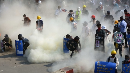 Protesters brave tear gas fired at them by police during a demonstration against the military coup in Kale, Myanmar on March 2. Demonstrators in Myanmar protesting last month's military coup returned to the streets on March 4, undeterred by the killing of at least 38 people the previous day by security forces, AP reported.(AFP)