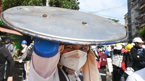 A protester holds a homemade shield during a demonstration against the military coup in Yangon on March 3. New protests were held in at least three areas of Yangon, Myanmar’s largest city, which has been scenes of violence for the past few days.(AFP)