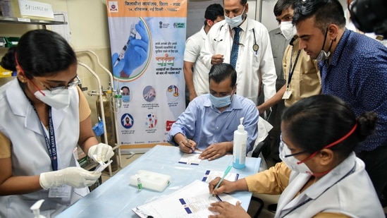 Delhi chief minister Arvind Kejriwal fills the form to get the Covid-19 vaccine during the second phase of vaccination at LNJP Hospital in New Delhi on Thursday.(ANI Photo) Delhi chief minister Arvind Kejriwal fills the form to get the Covid-19 vaccine during the second phase of vaccination at LNJP Hospital in New Delhi on Thursday.(ANI Photo)