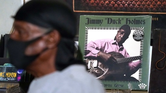 An album cover featuring the portrait of blues performer Jimmy "Duck" Holmes peers behind the bluesman as he talks of the area musicians from whom he learned the style of the Bentonia Blues, during an interview at the Blue Front Cafe in Bentonia, Miss., Jan. 21, 2021. Holmes' ninth album, "Cypress Grove," has earned a Grammy nomination for the Best Traditional Blues Album. (AP)