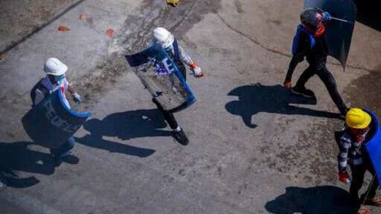 Anti-coup protesters walk with makeshift shields ahead of a demonstration in Yangon, Myanmar Thursday, March 4, 2021. (AP Photo ) Anti-coup protesters walk with makeshift shields ahead of a demonstration in Yangon, Myanmar Thursday, March 4, 2021. (AP Photo )