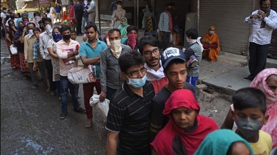 People queue up to take foodgrains from a government PDS shop in New Delhi. (Sanchit Khanna/HT PHOTO)