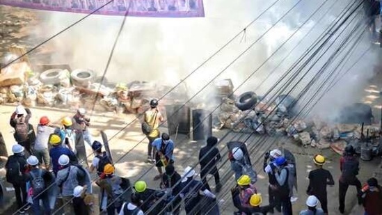 Anti-coup protesters maintain their position behind a barricade despite smoke from tear gas in San Chaung township in Yangon, Myanmar.(AP) Anti-coup protesters maintain their position behind a barricade despite smoke from tear gas in San Chaung township in Yangon, Myanmar.(AP)