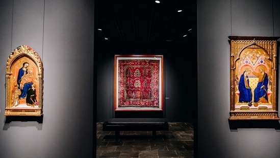 Early Italian religious paintings from 1280-1470 on either side of the entrance to a room of silk and pashmina Indian carpets from 1630-1650 at the Frick Collection's new museum location on Madison Avenue in New York, U.S., on Tuesday, March 2, 2021. (Bloomberg)