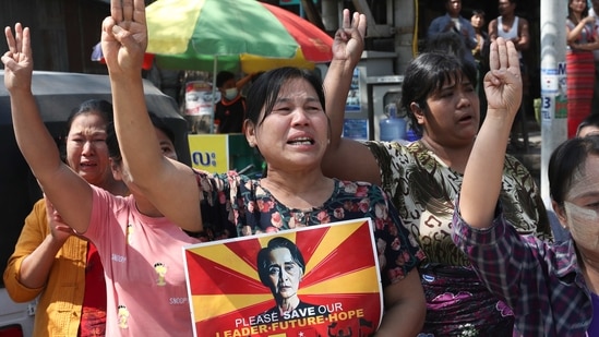 Women hold a portrait of deposed Myanmar leader Aung San Suu Kyi, during an anti-coup demonstration in Mandalay, Myanmar, Friday, March 5, 2021. Protests continue in Myanmar against the Feb 1 military coup that ousted the civilian government of Aung San Suu Kyi. Despite daily operations by police to disperse the crowds, defiant protesters continue to return to the streets in parts of the country.(AP Photo)(AP) Women hold a portrait of deposed Myanmar leader Aung San Suu Kyi, during an anti-coup demonstration in Mandalay, Myanmar, Friday, March 5, 2021. Protests continue in Myanmar against the Feb 1 military coup that ousted the civilian government of Aung San Suu Kyi. Despite daily operations by police to disperse the crowds, defiant protesters continue to return to the streets in parts of the country.(AP Photo)(AP)
