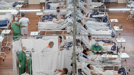 Covid-19 patients lie on beds at a field hospital built inside a sports coliseum in Santo Andre, on the outskirts of Sao Paulo, Brazil, Thursday,(AP)