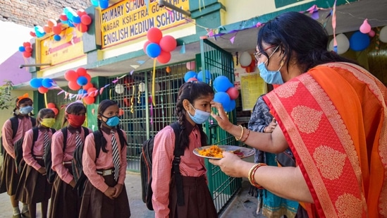 A teacher welcomes students at a school in Gorakhpur in March.(PTI) A teacher welcomes students at a school in Gorakhpur in March.(PTI)