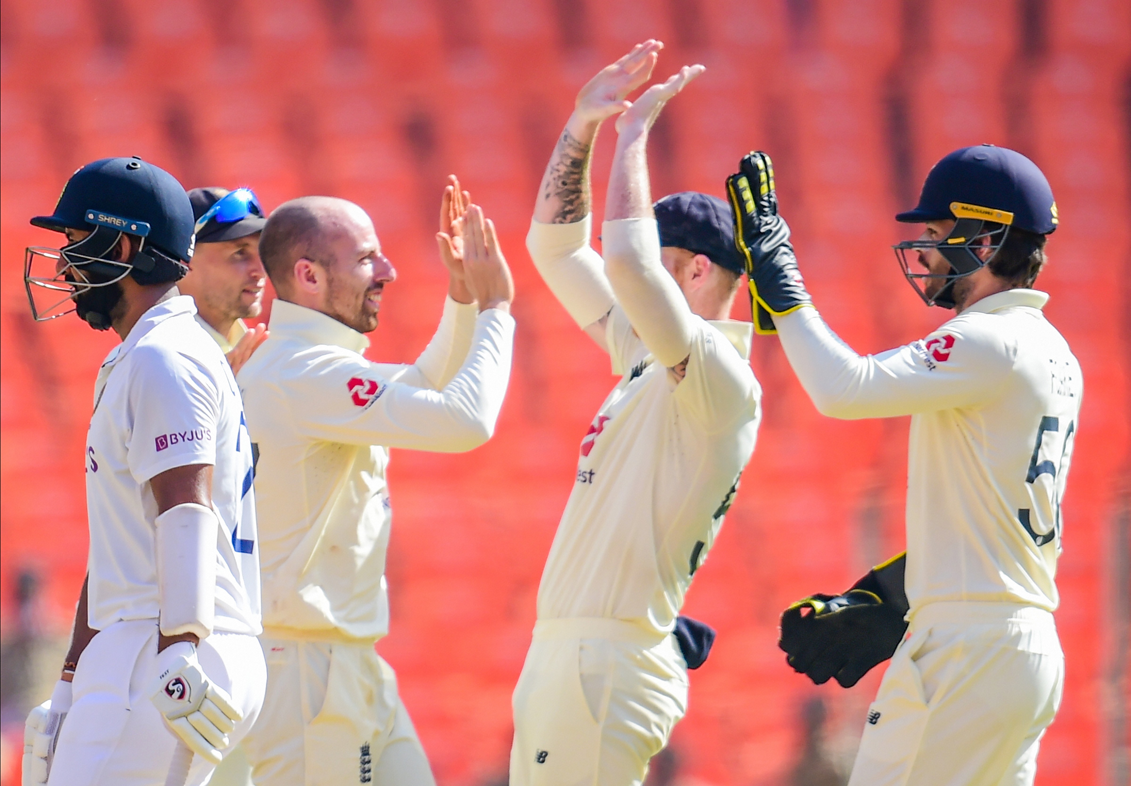 England spinner Jack Leach (2L) celebrates with teammates after dismissing Indian batsman C Pujara (L), during second day's play of the 4th and last cricket test match of the series between India and England, at Narendra Modi Stadium in Ahmedabad, Friday (PTI) England spinner Jack Leach (2L) celebrates with teammates after dismissing Indian batsman C Pujara (L), during second day's play of the 4th and last cricket test match of the series between India and England, at Narendra Modi Stadium in Ahmedabad, Friday (PTI)