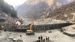 Border Roads Organisation (BRO) workers engaged in building a valley bridge over the Rishi Ganga River at Raini village of the disaster-hit Chamoli district. (PTI) Border Roads Organisation (BRO) workers engaged in building a valley bridge over the Rishi Ganga River at Raini village of the disaster-hit Chamoli district. (PTI)