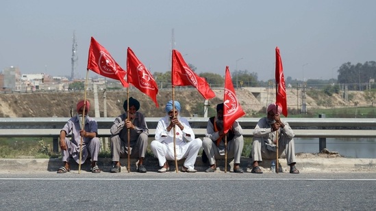 A group of farmers sitting on a highway with flags as they take part in a road blockade to mark the 100th day of the protest against new farm laws, near Kundli Border on March 6. Farmers blocked the Eastern and Western Peripheral Expressway on the edges of New Delhi to mark the 100th day of protests against agricultural laws they say will devastate their incomes. A group of farmers sitting on a highway with flags as they take part in a road blockade to mark the 100th day of the protest against new farm laws, near Kundli Border on March 6. Farmers blocked the Eastern and Western Peripheral Expressway on the edges of New Delhi to mark the 100th day of protests against agricultural laws they say will devastate their incomes.