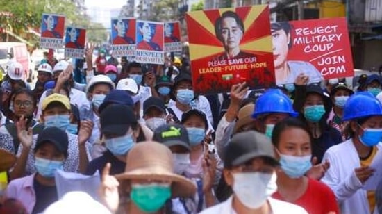 Anti-coup protesters hold up images of deposed leader Aung San Suu Kyi as they gather in Yangon, Myanmar.(AP) Anti-coup protesters hold up images of deposed leader Aung San Suu Kyi as they gather in Yangon, Myanmar.(AP)
