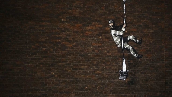 A mural of artist Banksy is seen on a wall at HM Reading Prison in Reading, Britain in this picture obtained from the artist's official Instagram account. @banksy/banksy.co.uk (@BANKSY via REUTERS)