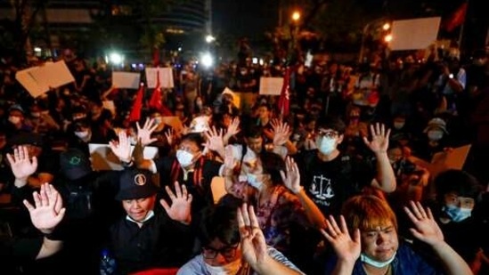 Anti-government protesters gesture, outside the Criminal court during a protest in Bangkok, Thailand.(AP)