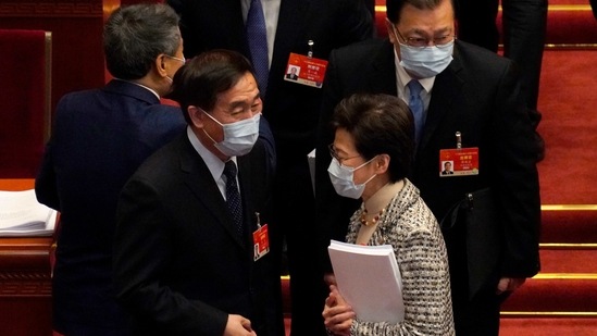 Hong Kong Chief Executive Carrie Lam, right, talks with fellow delegates after the opening session of China's National People's Congress (NPC).(AP) Hong Kong Chief Executive Carrie Lam, right, talks with fellow delegates after the opening session of China's National People's Congress (NPC).(AP)