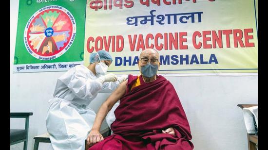 Tibetan spiritual leader the Dalai Lama being given the first shot of the Covid-19 vaccine at Zonal Hospital, Dharamshala, on Saturday morning. (HT Photo)