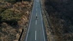 An aerial view shows Sakae Kato walking Pochi, his dog that he rescued four years ago, on an empty road between restricted zones in Namie, Fukushima Prefecture, Japan on February 20. A decade ago, Kato stayed behind to rescue cats abandoned by neighbours who fled the radiation clouds belching from the nearby Fukushima nuclear plant. An aerial view shows Sakae Kato walking Pochi, his dog that he rescued four years ago, on an empty road between restricted zones in Namie, Fukushima Prefecture, Japan on February 20. A decade ago, Kato stayed behind to rescue cats abandoned by neighbours who fled the radiation clouds belching from the nearby Fukushima nuclear plant.