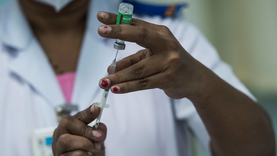 A health worker prepares a vaccine jab, at Rajawadi Hospital in Mumbai on March 5. According to the Union Health Ministry, 20,662,073 vaccine doses had been administered in India until March 6 evening.(Pratik Chorge / HT Photo)