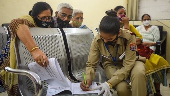 A Civil Defence personnel assists an elderly couple in Covid-19 vaccine registration, at Sanjeevan Hospital, in New Delhi on March 5. India kickstarted the first phase of its vaccination drive on January 16 when the most vulnerable group in the fight against Covid-19 -- healthcare and frontline workers -- were given vaccines.(Amal KS / HT Photo)