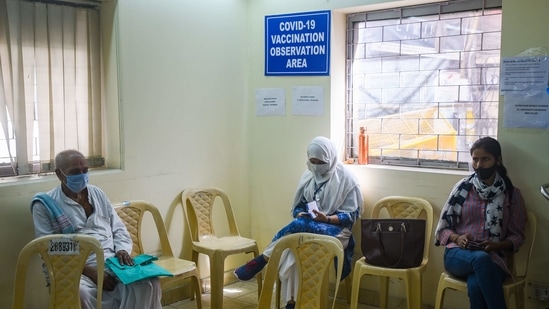 Beneficiaries are seen in the observation area after being vaccinated against Covid-19, at Sanjeevan Hospital, in New Delhi on March 5. As many as 69,72,859 healthcare and 65,02,869 frontline workers have received a jab against the infection until March 6 evening, HT reported.(Amal KS / HT Photo)