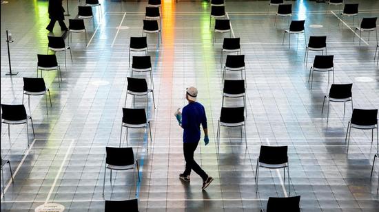 A file photo of an employee walking with sanitary wipes through the post-vaccination waiting area at a vaccination centre, as part of the Covid-19 vaccination campaign, in Brampton, Ontario, Canada. (REUTERS) A file photo of an employee walking with sanitary wipes through the post-vaccination waiting area at a vaccination centre, as part of the Covid-19 vaccination campaign, in Brampton, Ontario, Canada. (REUTERS)