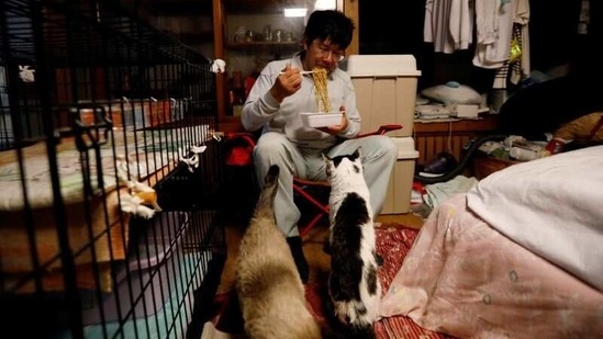 Sakae Kato eats instant noodles for dinner at his home in a restricted zone in Namie on February 20. The 57-year-old, a small construction business owner in his former life, says his decision to stay as 160,000 other people evacuated the area was spurred in part by the shock of finding dead pets in abandoned houses he helped demolish.(Kim Kyung-Hoon / REUTERS)