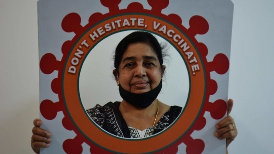 A woman gets photographed after being vaccinated against Covid-19 at a private hospital in Ghodbander Road, Thane on March 5. The government have also cleared private vaccination centres where people can get the jab at a set price.(Praful Gangurde / HT Photo)