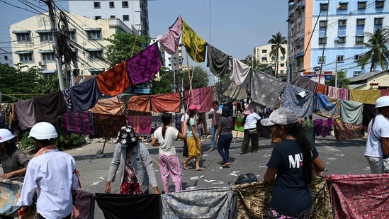 Protesters make a barricade across a road with longyi during a demonstration against the military coup in Yangon.(AFP) Protesters make a barricade across a road with longyi during a demonstration against the military coup in Yangon.(AFP)