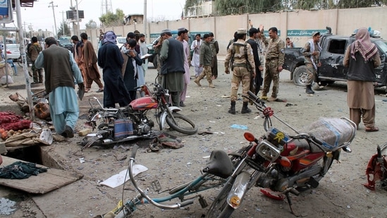 Helmand: Security personnel inspect the site of a deadly roadside bomb explosion in Helmand province, southern Afghanistan, Sunday, Feb. 21, 2021. Two separate roadside bomb explosions in Afghanistan on Sunday killed and wounded numerous people. AP/PTI(AP02_21_2021_000191A)(AP) Helmand: Security personnel inspect the site of a deadly roadside bomb explosion in Helmand province, southern Afghanistan, Sunday, Feb. 21, 2021. Two separate roadside bomb explosions in Afghanistan on Sunday killed and wounded numerous people. AP/PTI(AP02_21_2021_000191A)(AP)