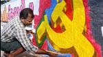 A CPI (M) worker paints a wall to campaign for LDF candidate ahead of assembly elections in Kozhikode. (File photo)