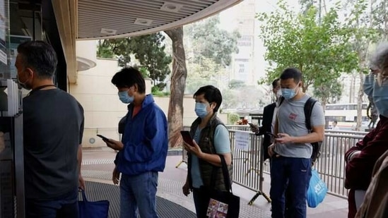 People queue up at a community vaccination centre to receive a dose of the Sinovac Biotech coronavirus disease (COVID-19) vaccine, in Hong Kong, China. (REUTERS) People queue up at a community vaccination centre to receive a dose of the Sinovac Biotech coronavirus disease (COVID-19) vaccine, in Hong Kong, China. (REUTERS)