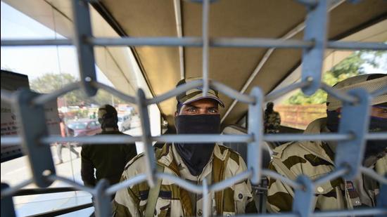 A security personnel looks through a shuttered Metro station gate. (PTI) A security personnel looks through a shuttered Metro station gate. (PTI)