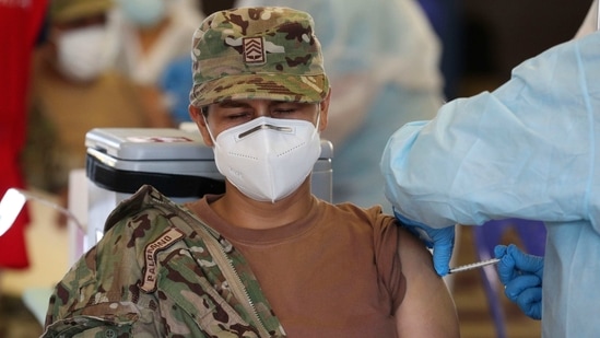 An Air Force member closes her eyes while getting a shot of Pfizer's vaccine for COVID-19 at a military base in Lima, Peru, Monday, March 8, 2021. (AP Photo/Martin Mejia)(AP) An Air Force member closes her eyes while getting a shot of Pfizer's vaccine for COVID-19 at a military base in Lima, Peru, Monday, March 8, 2021. (AP Photo/Martin Mejia)(AP)