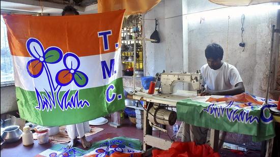 A worker stitches TMC party flags, in Howrah, West Bengal on March 7. (PTI) A worker stitches TMC party flags, in Howrah, West Bengal on March 7. (PTI)