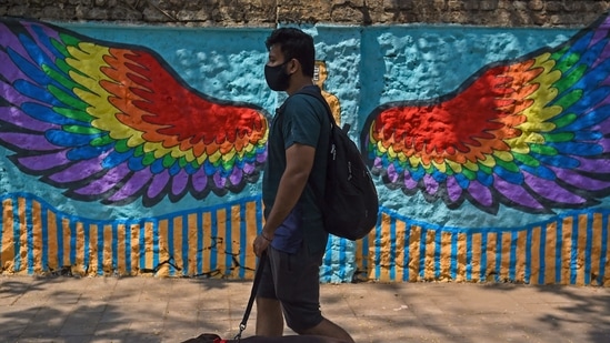 A pedestrian walks past a wall mural in Mumbai on March 6, 2021. (AFP) A pedestrian walks past a wall mural in Mumbai on March 6, 2021. (AFP)