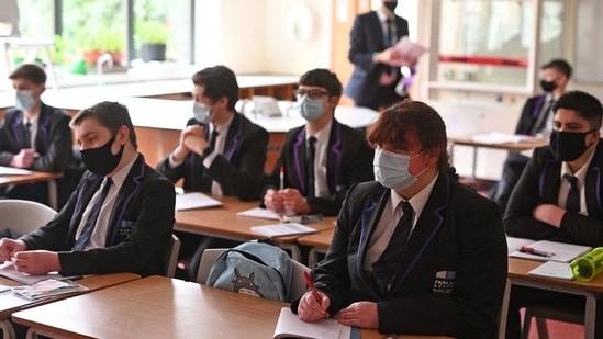 Year 11 students, wearing face coverings, take part in a GCSE science class at Park Lane Academy in Halifax, northwest England on March 8, 2021. (AFP) Year 11 students, wearing face coverings, take part in a GCSE science class at Park Lane Academy in Halifax, northwest England on March 8, 2021. (AFP)