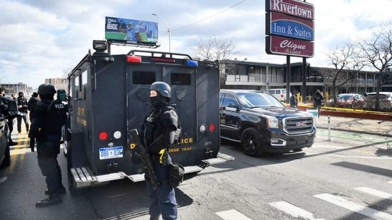 Detroit police monitor the scene of a shooting at the Rivertown Inn and Suites on East Jefferson Avenue in Detroit.(AP) Detroit police monitor the scene of a shooting at the Rivertown Inn and Suites on East Jefferson Avenue in Detroit.(AP)