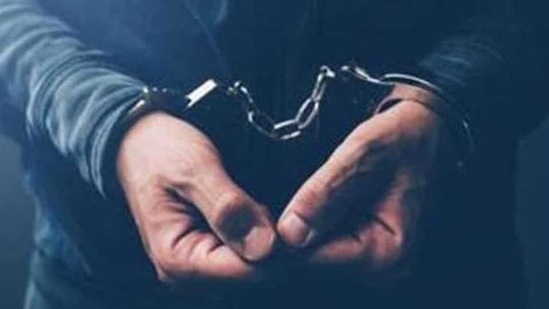Arrested computer hacker and cyber criminal with handcuffs, close up of hands(Getty Images/iStockphoto)