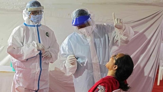 Healthcare workers at Covid-19 testing centre in Pune, India, on Sunday, December 13, 2020.(Ravindra Joshi/HT PHOTO)