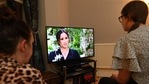 A family gather around the television to watch Prince Harry and his wife Meghan's explosive tell-all interview on CBS with Oprah Winfrey.(AFP) A family gather around the television to watch Prince Harry and his wife Meghan's explosive tell-all interview on CBS with Oprah Winfrey.(AFP)
