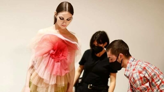 A model wearing a creation by designer Maria Grazia Chiuri for fashion house Dior poses during an interview with Reuters ahead of her Fall/Winter 2021 collection presentation in a digital format during Paris Fashion week, in Aubervilliers, near Paris, France, March 6, 2021.  (REUTERS)