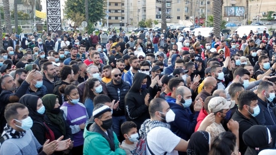 Demonstrators gather during a protest against the fall in Lebanese pound currency and mounting economic hardships, in Sidon, Lebanon March 8, 2021. (REUTERS)