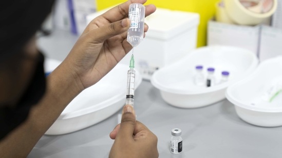 A health worker fills a syringe with a diluent for with the Pfizer-BioNTech Covid-19 vaccine at the Senja-Cashew Community Centre Vaccination Centre, operated by Thomson Medical, in Singapore, on Monday (Bloomberg)